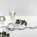 wine glasses and holly on table with ribbon